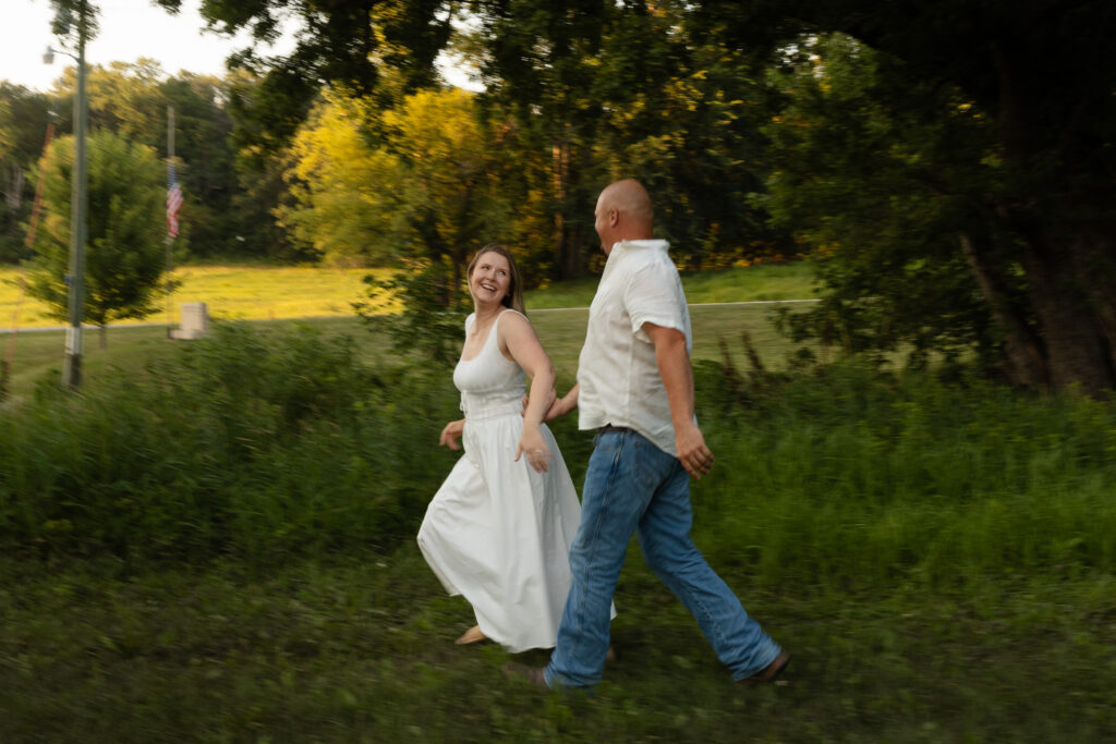 Blurry picture of couple running around during an engagement session at Wildcat Bluff Recreation Area in Vinton, IA.