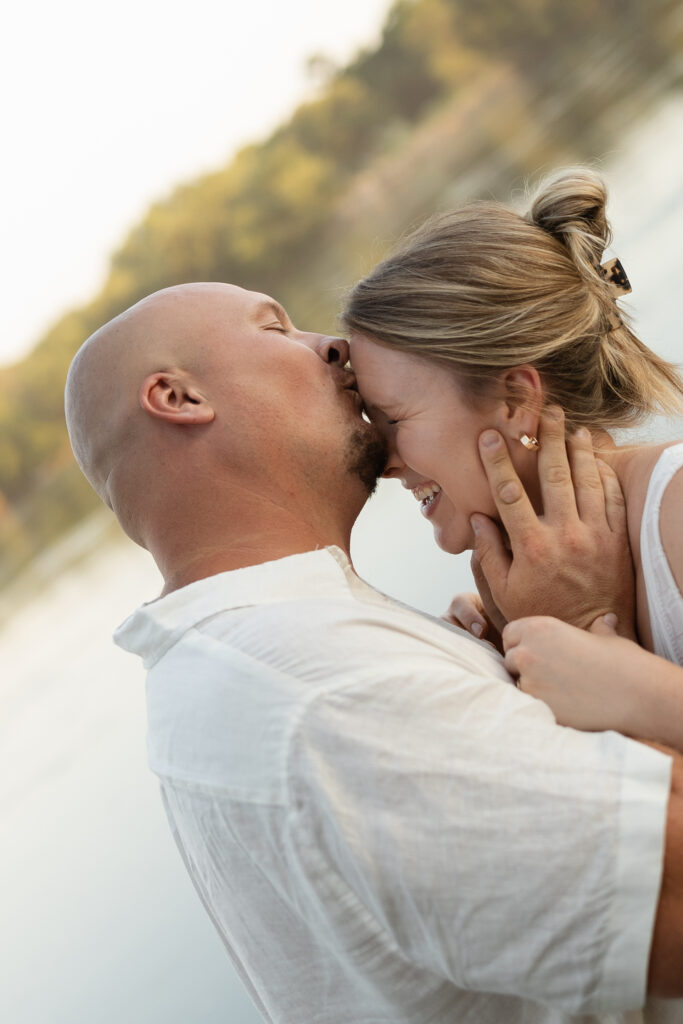 Couple laughing in the water at Wildcat Bluff Recreation Area in Vinton, IA.