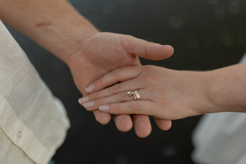 Couple holding hands over the water at Wildcat Bluff Recreation Area in Vinton, IA.