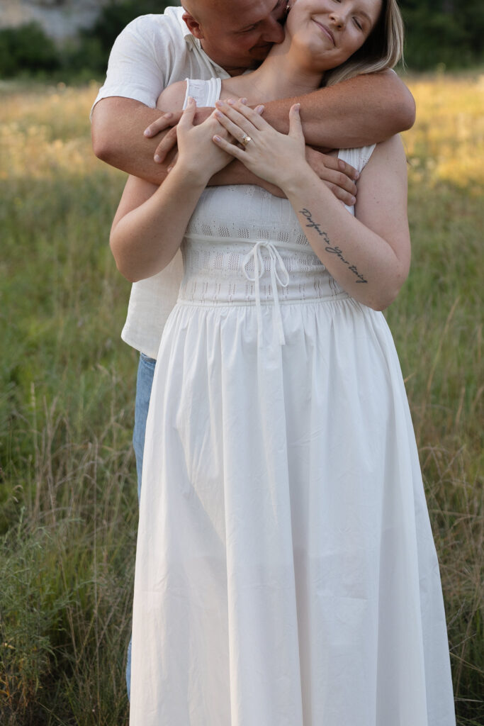 Couple with arms wrapped around each other at Wildcat Bluff Recreation Area in Vinton, IA.