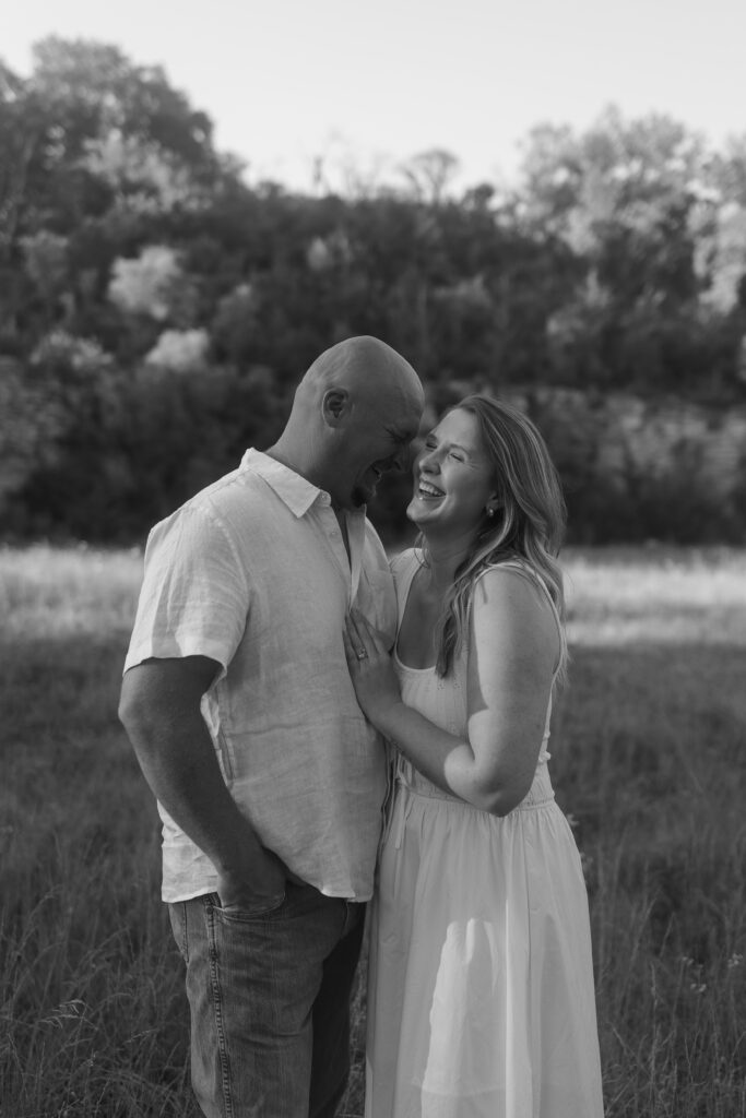 Couple laughing in black and white at Wildcat Bluff Recreation Area in Vinton, IA.